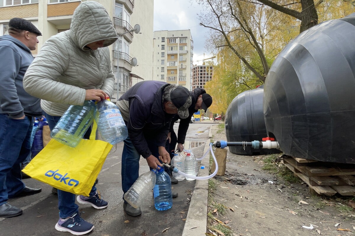 мешканці набирають воду в пляшки зі спеціальних ємностей