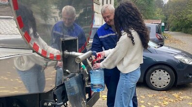 жінка набирає воду з водовозки