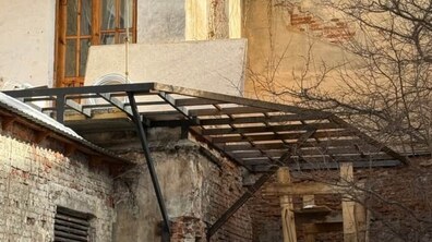 недобудована балконна конструкція на фоні стін будівлі.