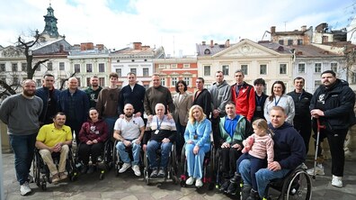 Спільне фото: учасники команд-фіналістів «Кубку Титанів - 2026» – «ТИТАНИ-Львів» та «Харків-Баскет», мер Львова Садовий та працівники офісу спорту міста – на балконі кабінету міського голови; всі усміхаються. Позаду видно міську панораму.